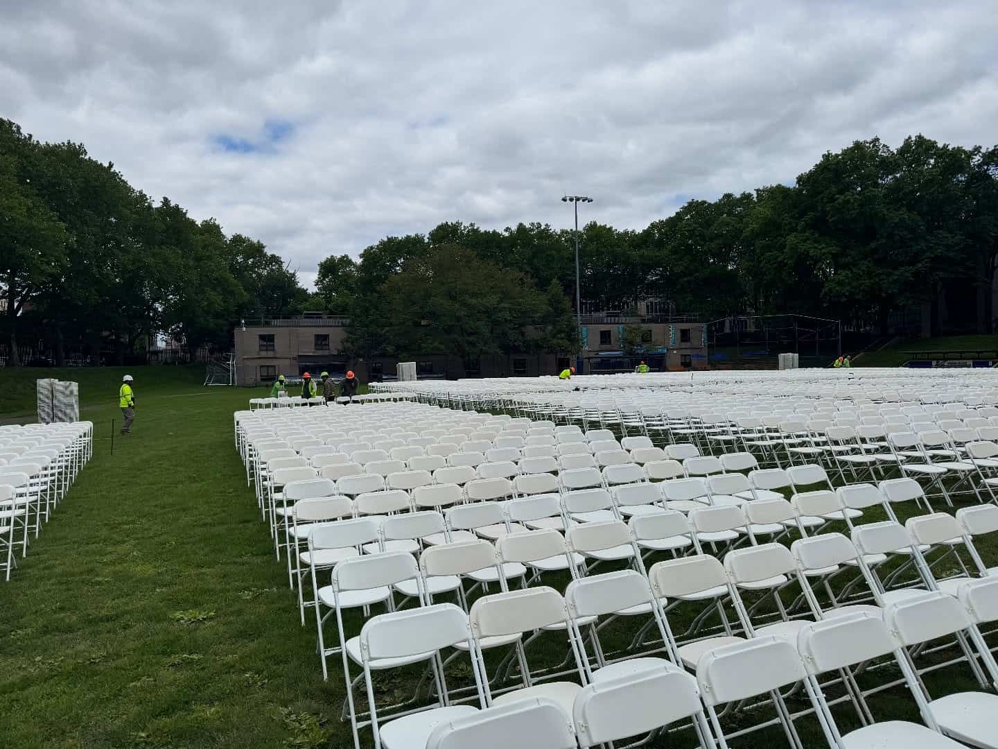 Graduation party tent with the sides rolled up over a backyard setup
