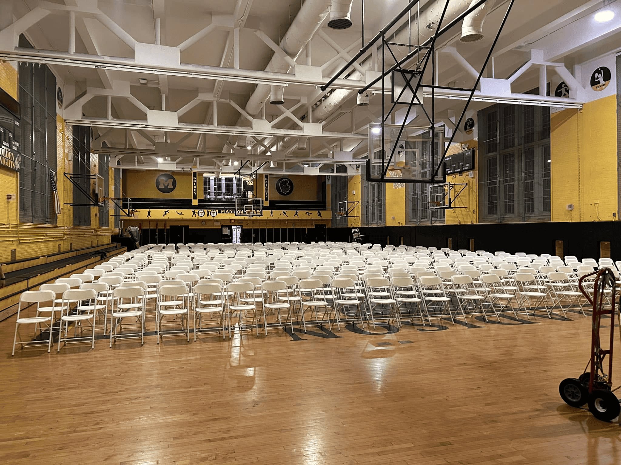 Graduation celebration under a white tent with guest seating in rows