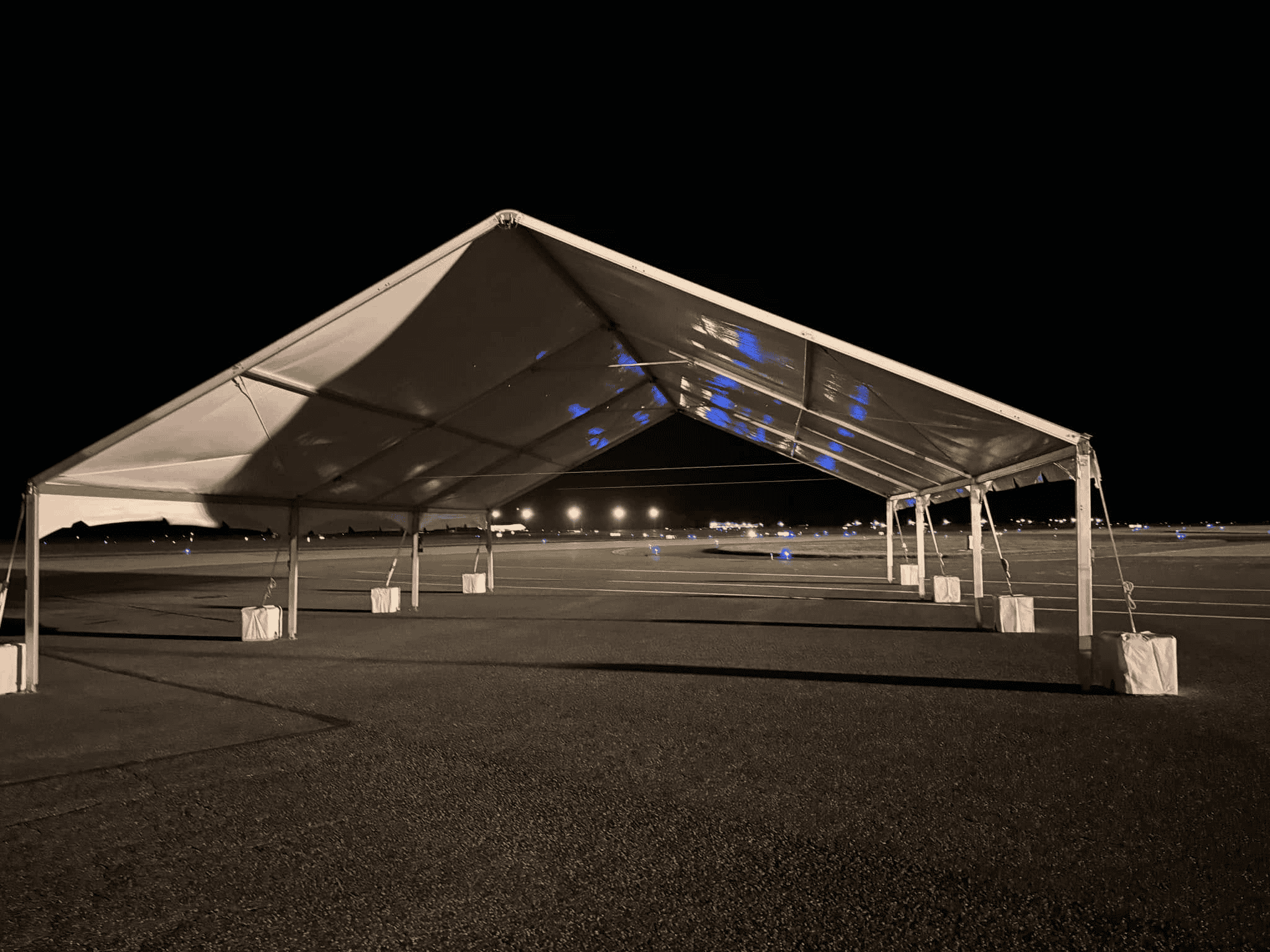 Lit tent interior at night with working lighting overhead