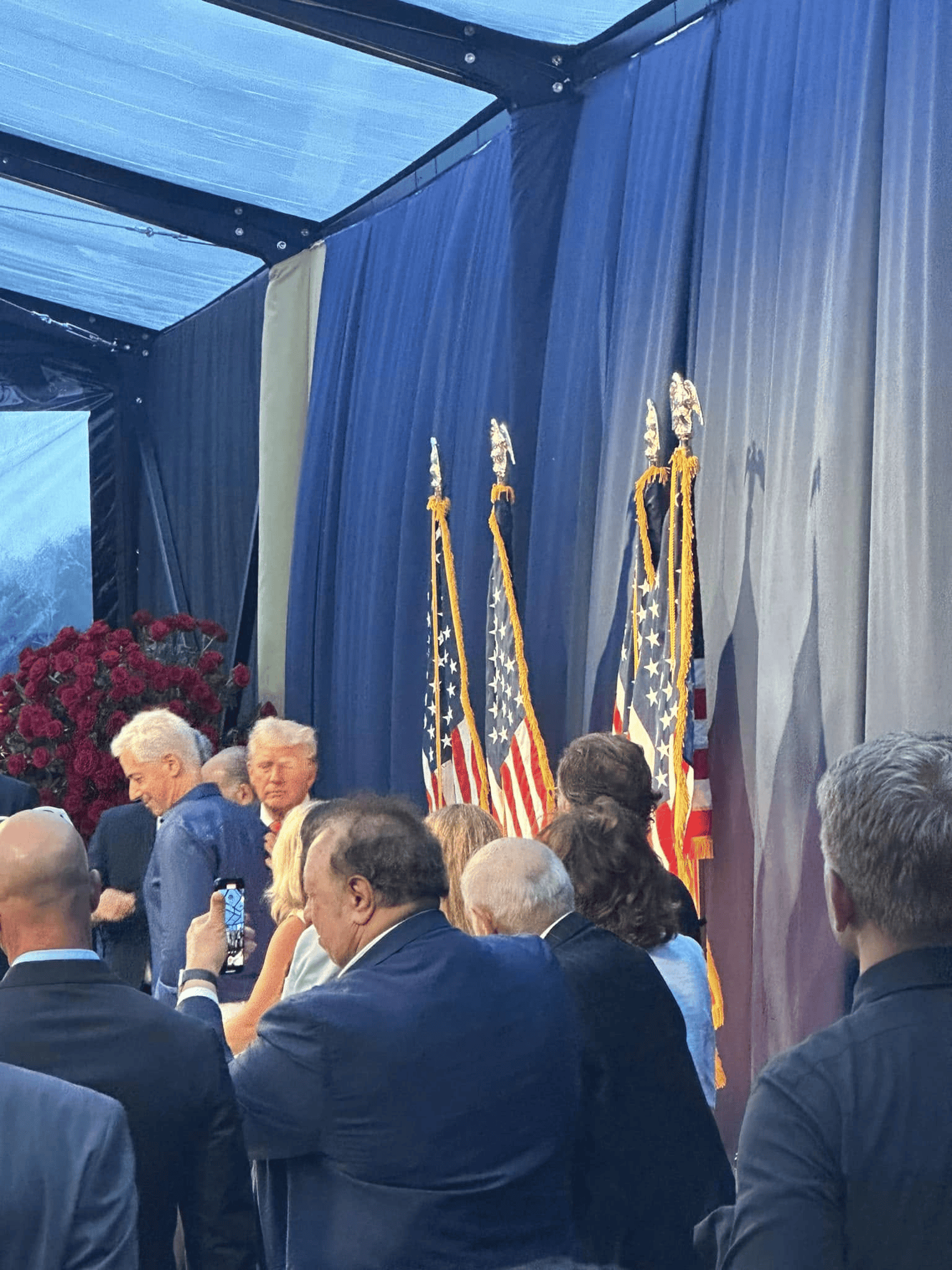 Corporate tent interior with tables and lighting hung from the frame