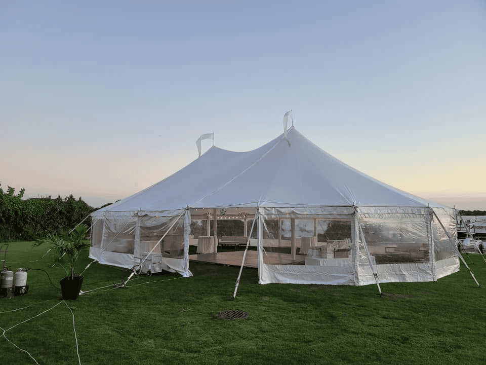 Evening private event with seating and lighting under a tent