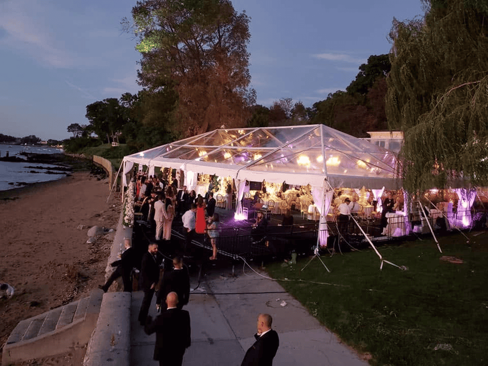 Clear top tent lit from inside with the roof panels showing the night sky above