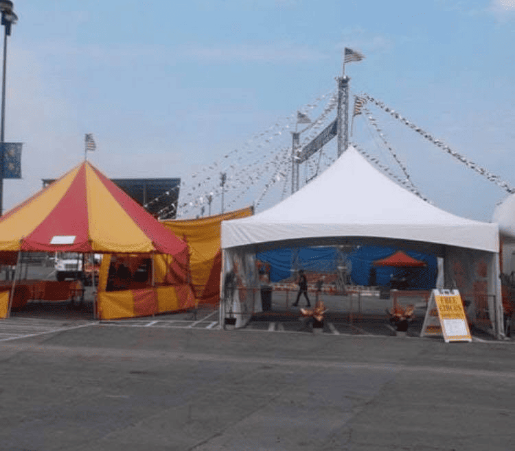 Peaked frame tent with open sides at an outdoor party