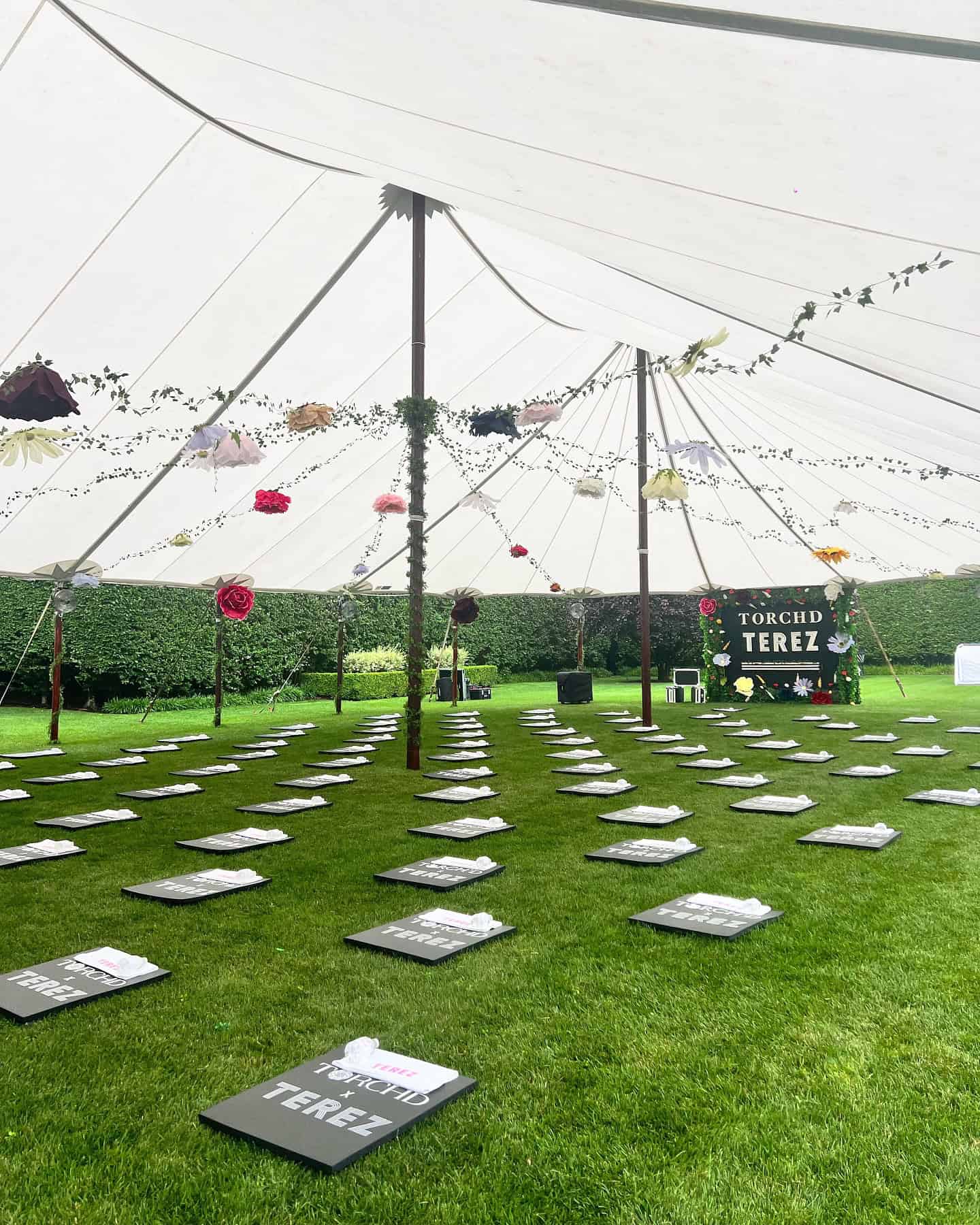 Sailcloth tent on a lawn with the sides left open