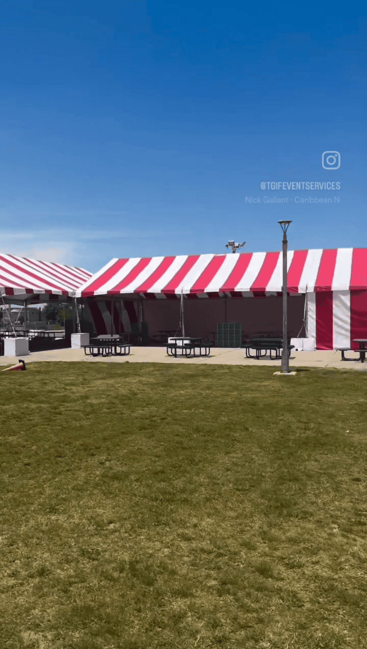 Wide span tent interior with seating laid out across the full width of the room