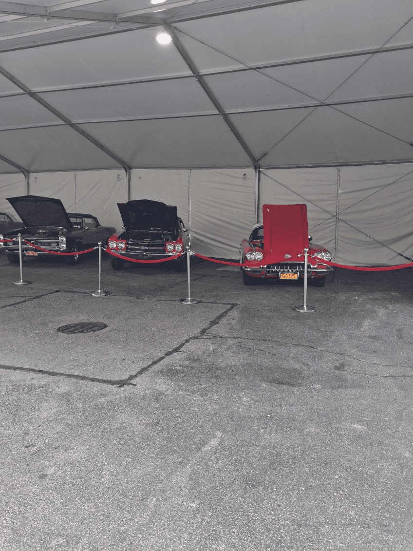 Open gable end of a wide clearspan tent giving vehicle access to the floor