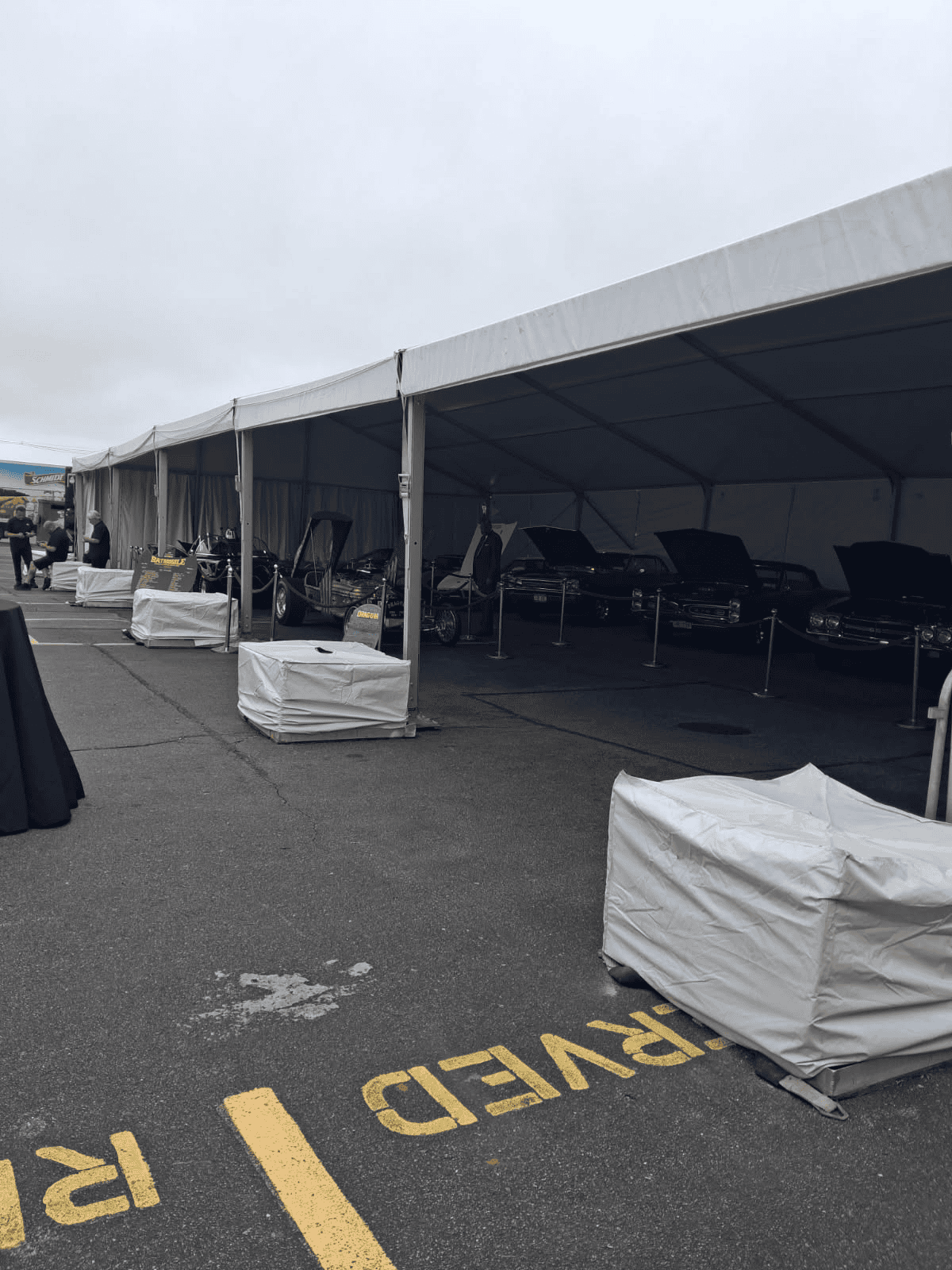 Track tent with window walls fitted around the perimeter for an outdoor event