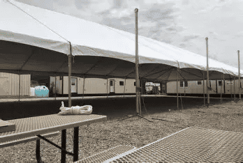 Wide clearspan tent covering an open floor with no interior poles