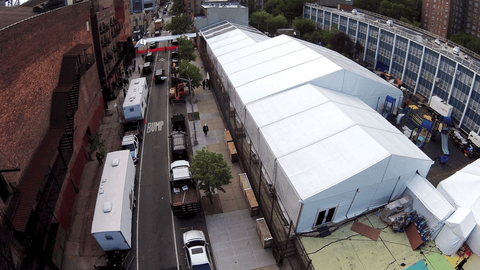 Rooftop tent lit from inside in the evening above a city street