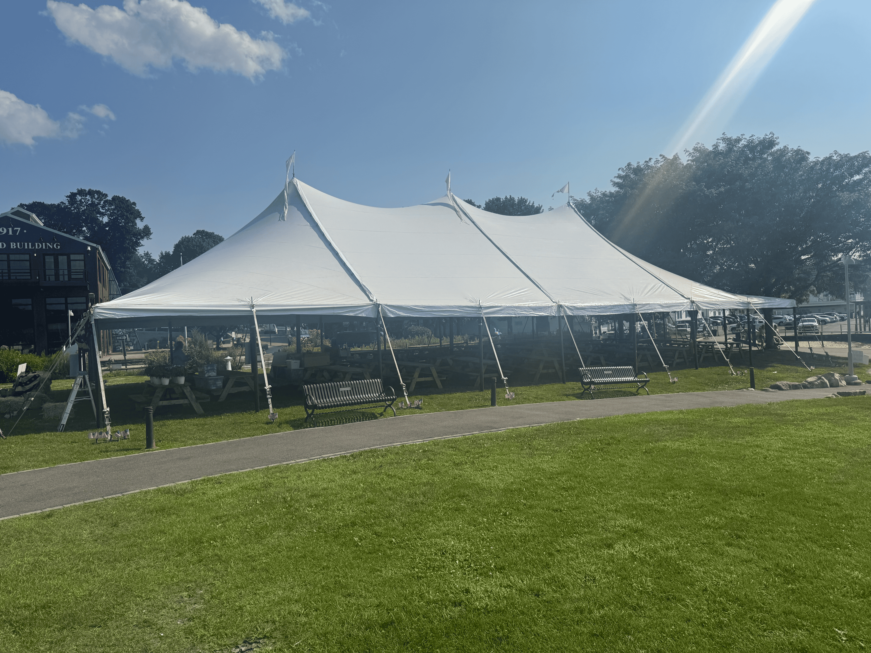 Center pole tent with guy ropes staked out around the perimeter